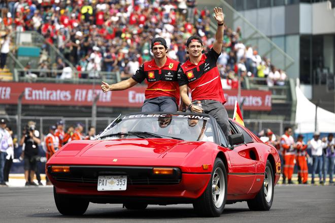 FILE PHOTO: Ferrari’s Monegasque driver Charles Leclerc (right) and Spanish driver Carlos Sainz (left) wave to the crowd on the drivers parade prior to the F1 Grand Prix of Mexico at Autodromo Hermanos Rodriguez on October 30, 2022 in Mexico City, Mexico. 