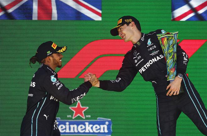 Mercedes’s British drivers George Russell (right), race winner, and Lewis Hamilton (left), runner-up, celebrate on the podium during the F1 Grand Prix of Brazil at Autodromo Jose Carlos Pace on November 13, 2022 in Sao Paulo, Brazil.